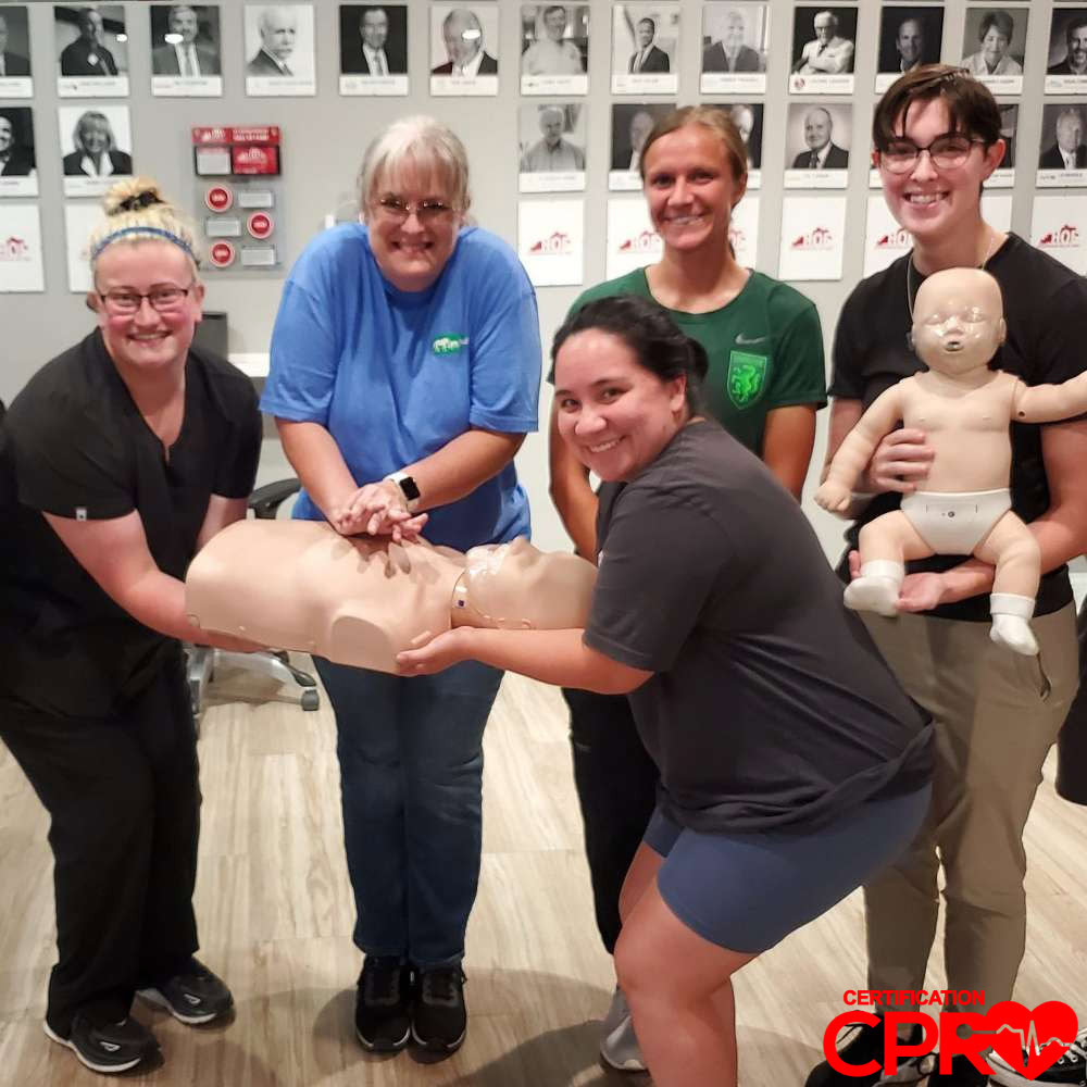 CPR training class in Lakeland with students practicing on mannequins.